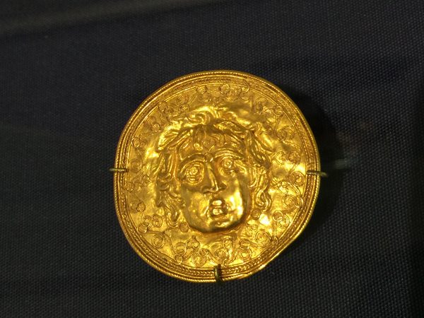 Etruscan gold medallion with face image and gemologist Elizabeth Van Tassel